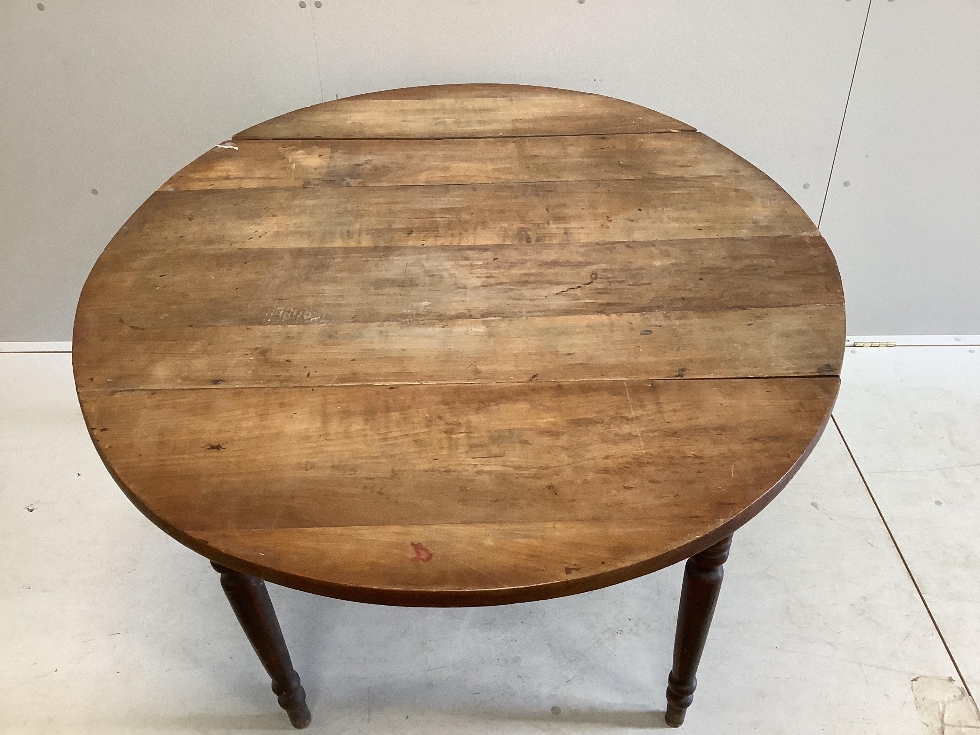 A 19th century French cherry drop flap dining table, 148cm extended, depth 111cm, height 74cm
